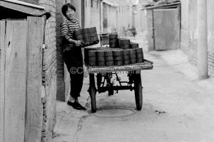 Woman Delivering Coal Briquettes