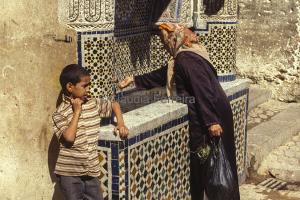 A Woman And A Boy In The Marrakech Medina