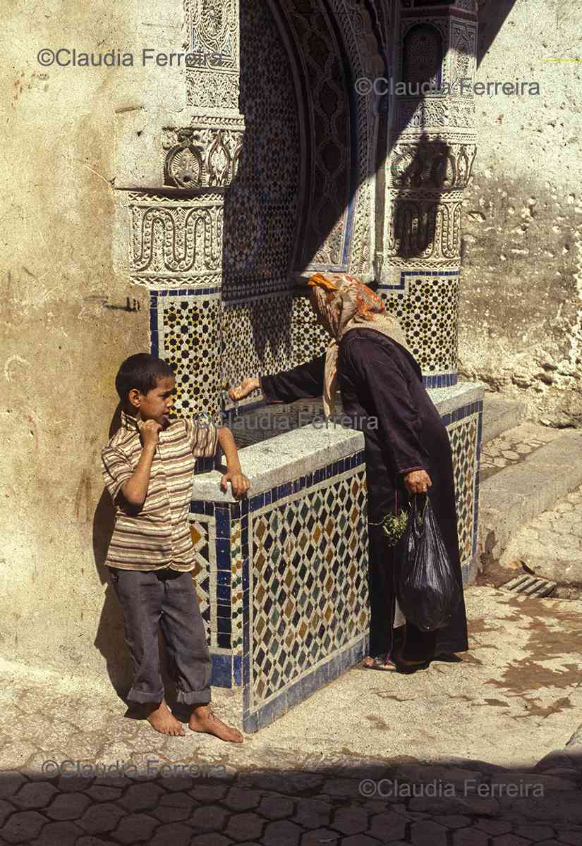 A Woman And A Boy In The Marrakech Medina